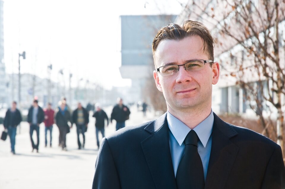 A businessman on a busy European shopping street