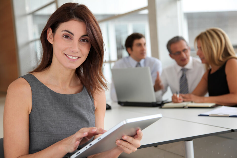 A consultant with a tablet during a client meeting
