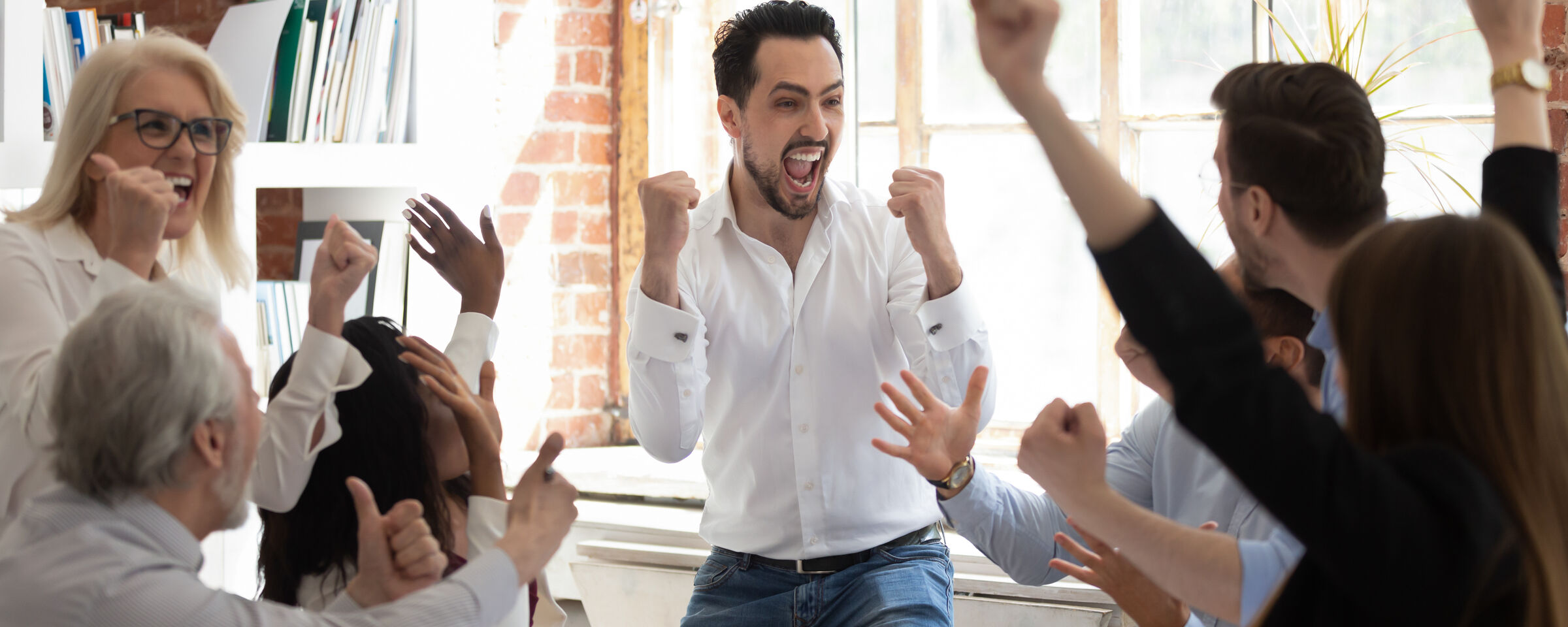 A team celebrating a successful result in a meeting room